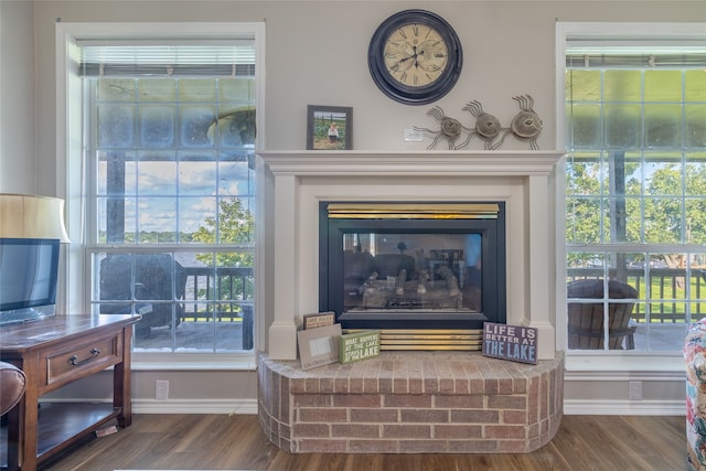 interior details with a brick fireplace and hardwood / wood-style flooring