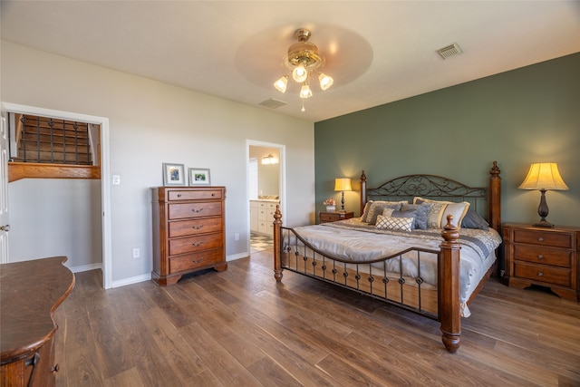 bedroom featuring ceiling fan, dark hardwood / wood-style flooring, and ensuite bath