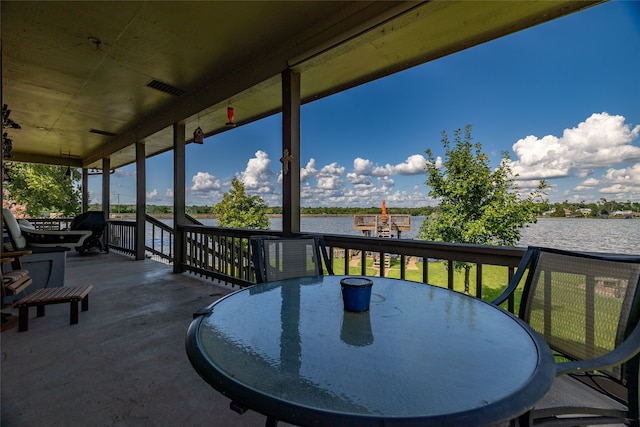 wooden deck featuring a water view