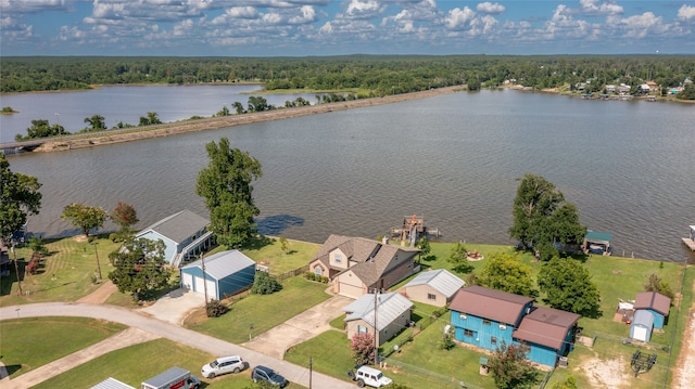 birds eye view of property with a water view