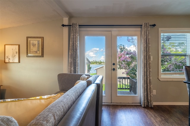 doorway featuring vaulted ceiling with beams, dark wood-type flooring, and french doors