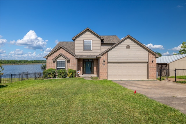 view of front facade featuring a water view, a garage, and a front lawn