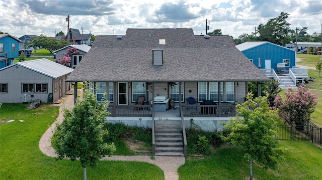 view of front of house with covered porch and a front lawn