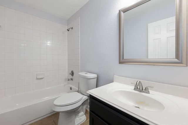 full bathroom with tile patterned floors, toilet, shower / washtub combination, vanity, and a textured wall