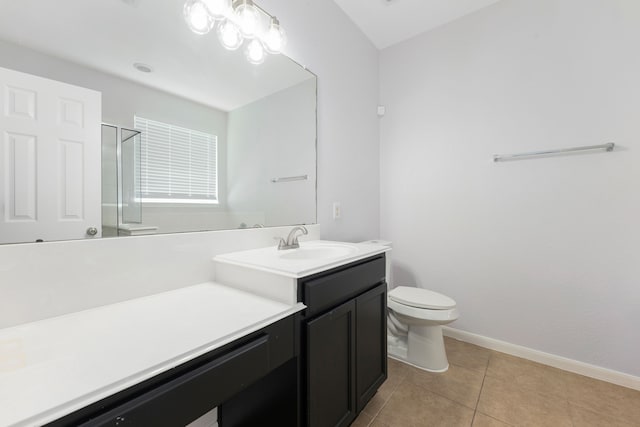 full bathroom featuring tile patterned flooring, a shower stall, baseboards, toilet, and vanity