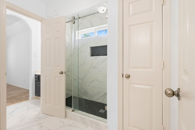 bathroom featuring vanity and a shower with shower door