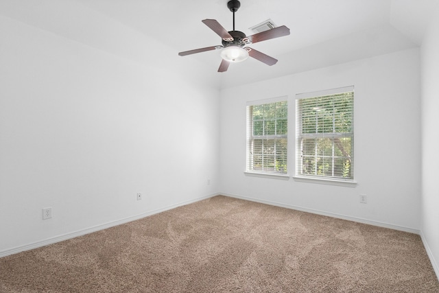 carpeted spare room featuring ceiling fan