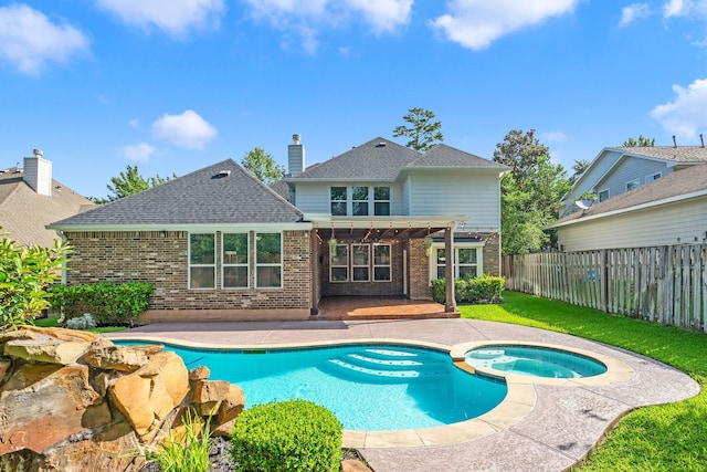 view of swimming pool with an in ground hot tub