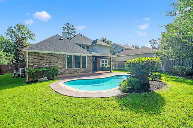 view of pool featuring a lawn and a patio area