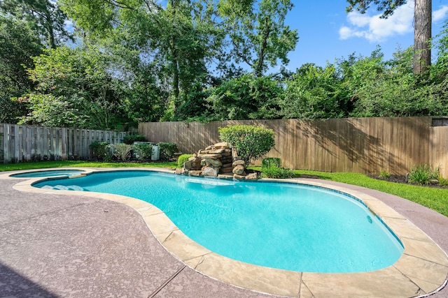 view of swimming pool featuring an in ground hot tub