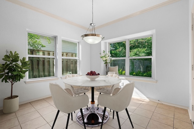 dining space with light tile patterned floors and ornamental molding