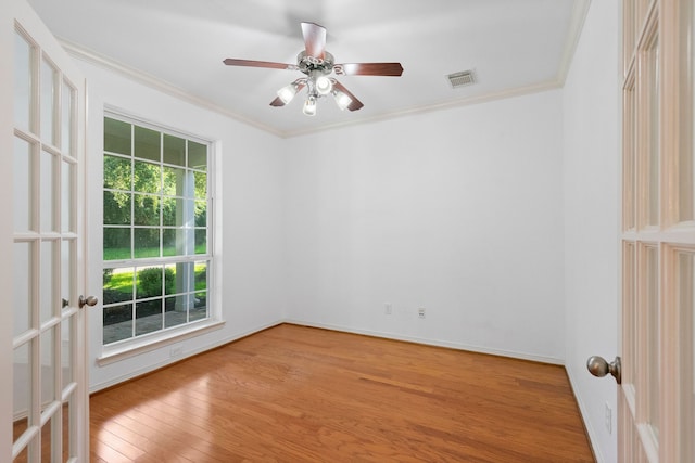 spare room featuring french doors, light hardwood / wood-style flooring, ceiling fan, and ornamental molding