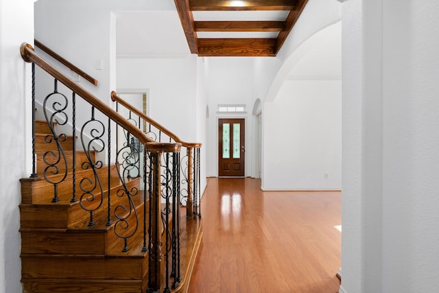 entrance foyer with hardwood / wood-style floors and beam ceiling