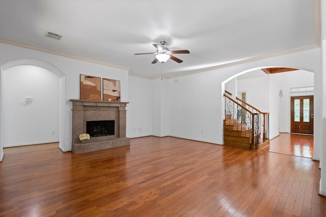 unfurnished living room with wood-type flooring, ceiling fan, and ornamental molding