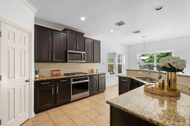 kitchen with sink, decorative light fixtures, crown molding, dark brown cabinets, and stainless steel appliances