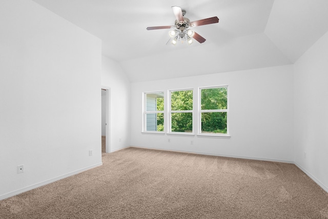 unfurnished room featuring ceiling fan, carpet floors, and vaulted ceiling