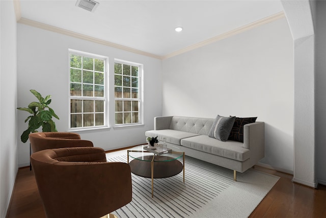 living room with dark wood-type flooring and ornamental molding