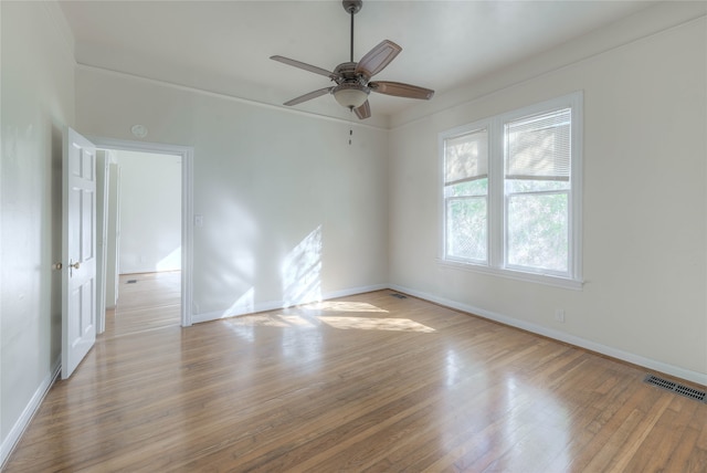 empty room featuring light hardwood / wood-style flooring, ceiling fan, and crown molding