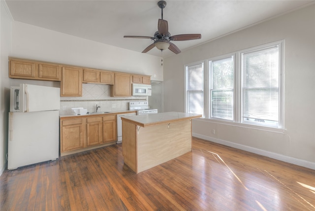 kitchen featuring decorative backsplash, a center island, white appliances, and dark wood-type flooring