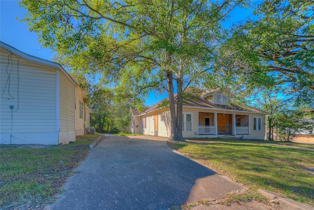 view of front of property with covered porch and a front yard