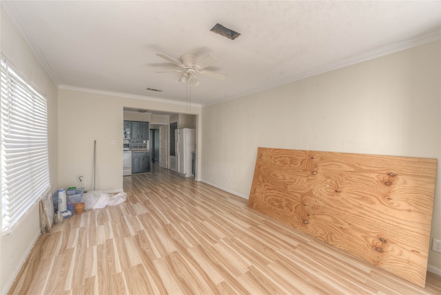 spare room with crown molding, light hardwood / wood-style flooring, and ceiling fan