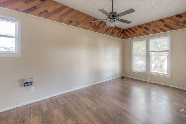 unfurnished room with ceiling fan, wood-type flooring, lofted ceiling, and a textured ceiling