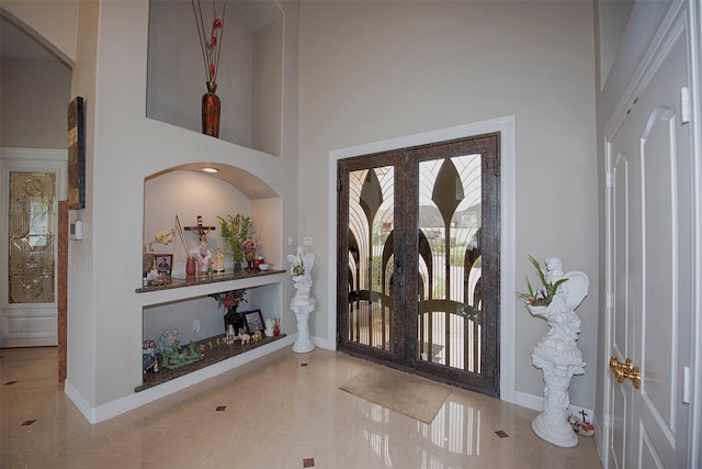 entryway with a high ceiling and french doors