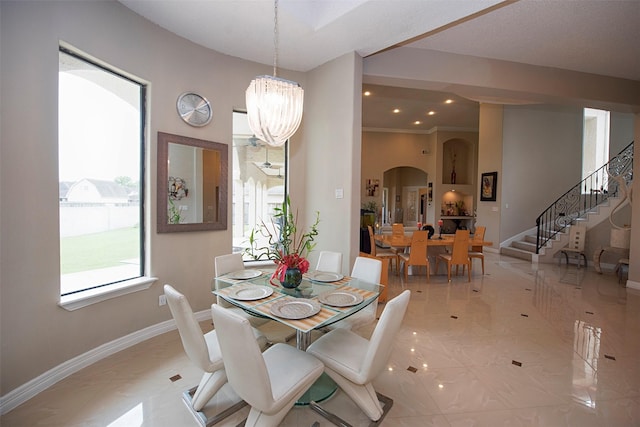 dining room featuring ornamental molding and an inviting chandelier