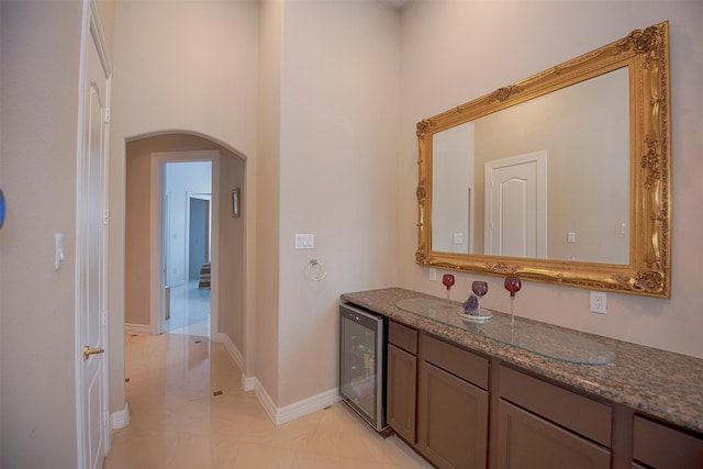 bathroom with beverage cooler and vanity