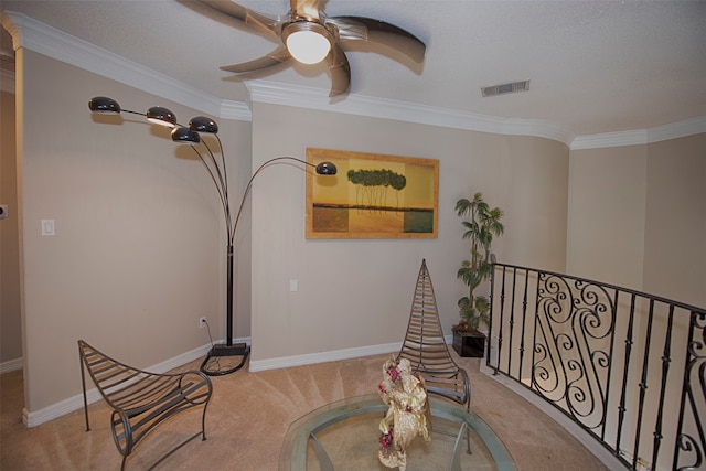 living area with light carpet, ceiling fan, and ornamental molding