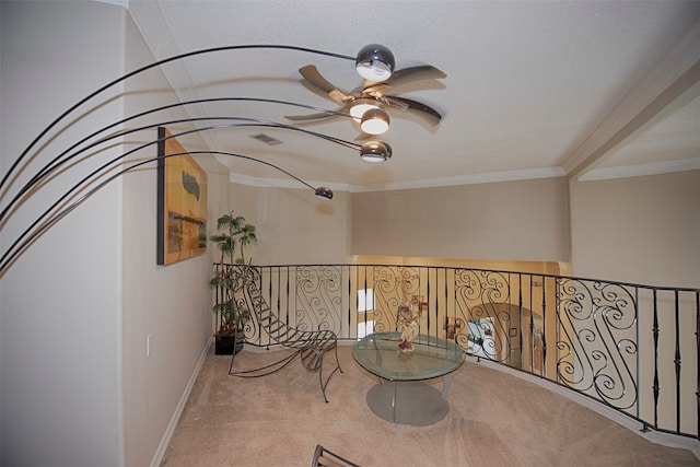 living area featuring ceiling fan, crown molding, and light colored carpet