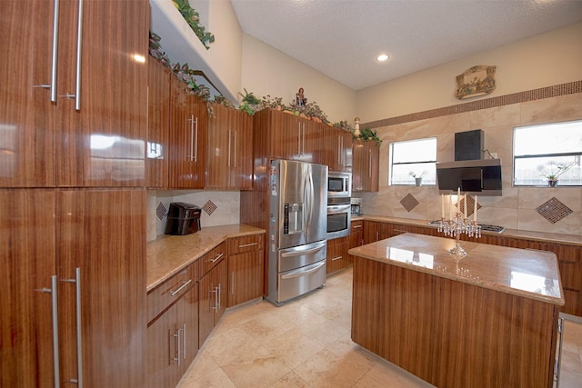 kitchen featuring appliances with stainless steel finishes, a center island, ventilation hood, and tasteful backsplash