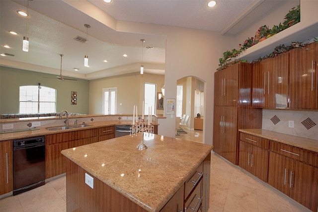 kitchen featuring a large island with sink, sink, hanging light fixtures, ceiling fan, and stainless steel dishwasher