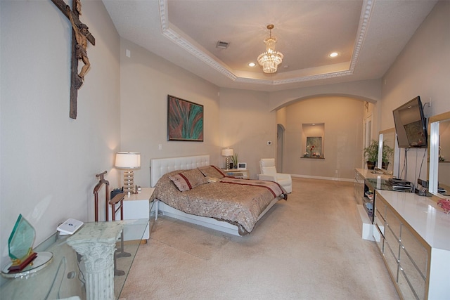 bedroom with light colored carpet, an inviting chandelier, and a tray ceiling