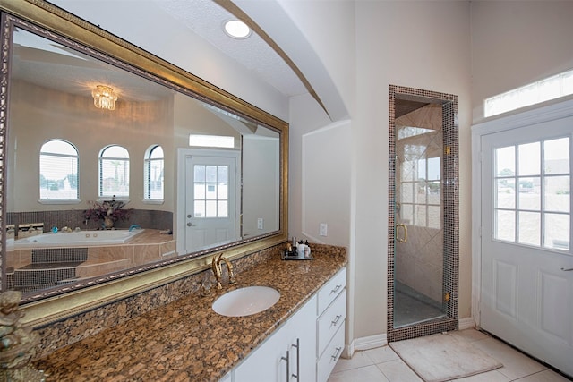 bathroom featuring plus walk in shower, a wealth of natural light, and tile patterned flooring