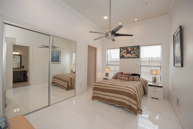 bedroom featuring ceiling fan, light tile patterned floors, a closet, and crown molding