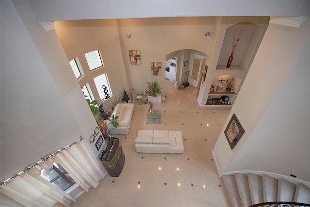 living room featuring a towering ceiling