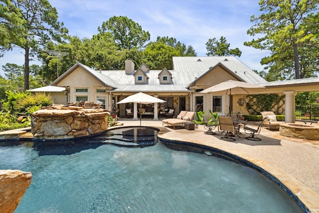 view of pool featuring a patio and an outdoor living space with a fire pit