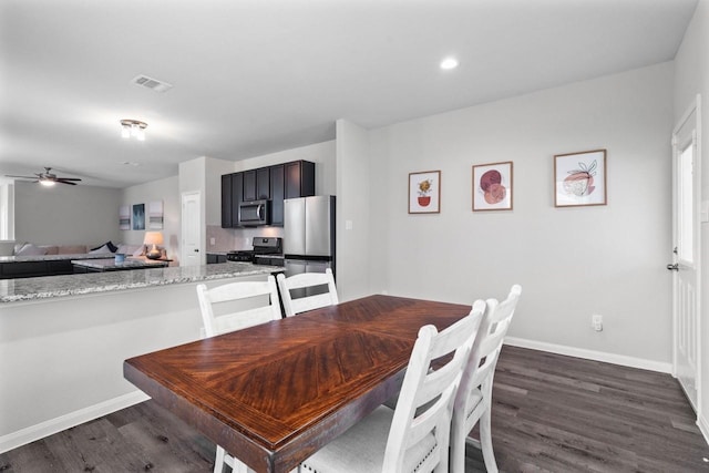 dining room with dark hardwood / wood-style flooring and ceiling fan