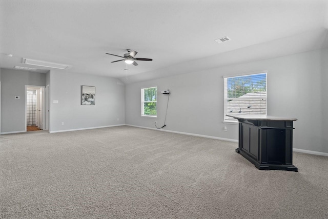 carpeted spare room featuring ceiling fan and a healthy amount of sunlight