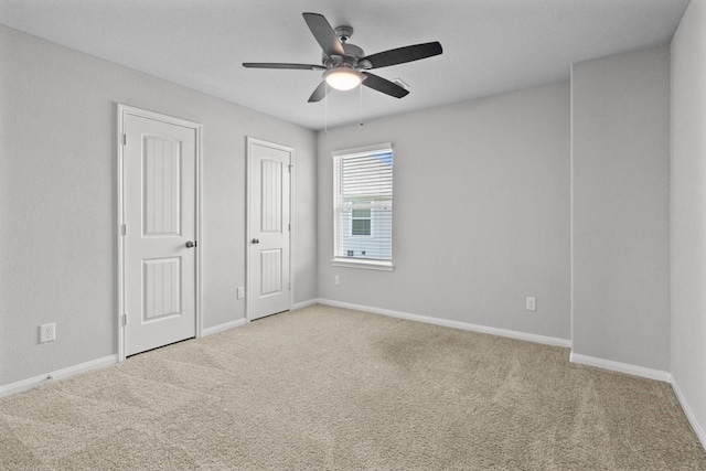 unfurnished bedroom with ceiling fan and carpet floors