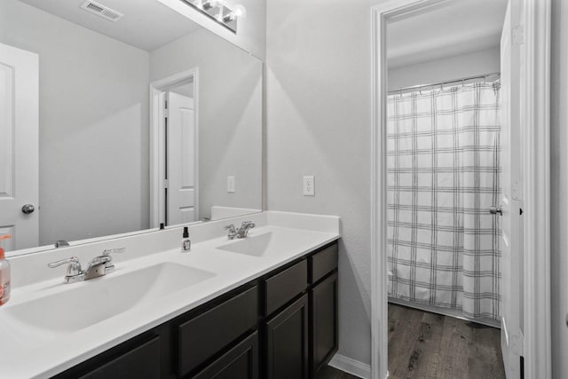 bathroom featuring vanity and hardwood / wood-style flooring