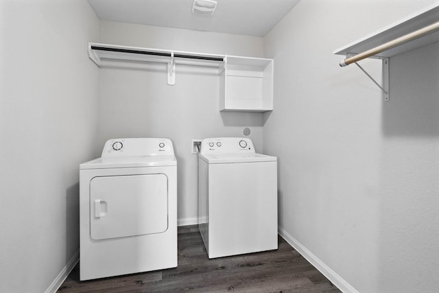 laundry room featuring washing machine and clothes dryer and dark wood-type flooring