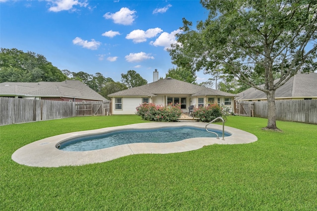 view of swimming pool featuring a yard and a patio area