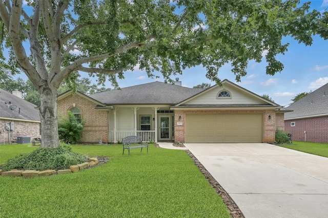 ranch-style home featuring a garage, a front lawn, and central AC unit