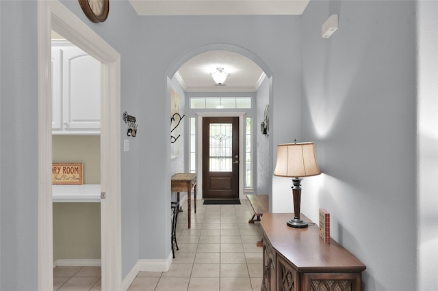 tiled foyer entrance with ornamental molding