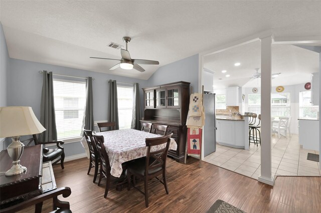 dining area featuring lofted ceiling, light hardwood / wood-style flooring, and ceiling fan