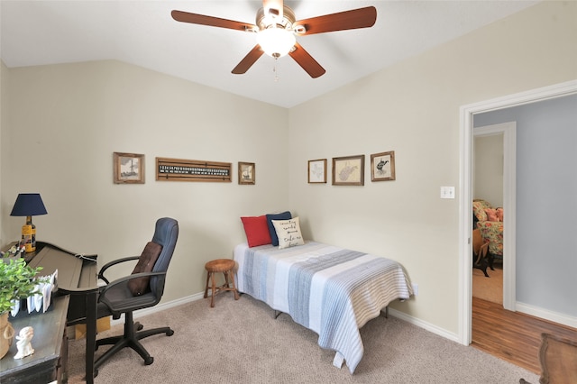 bedroom featuring lofted ceiling, ceiling fan, and light wood-type flooring