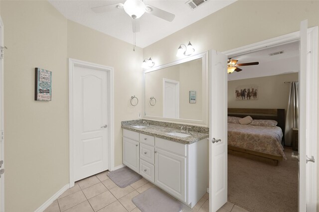 bathroom featuring tile patterned floors, ceiling fan, and dual bowl vanity