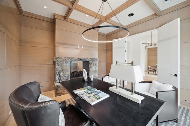 dining area with a fireplace, coffered ceiling, beam ceiling, and a notable chandelier